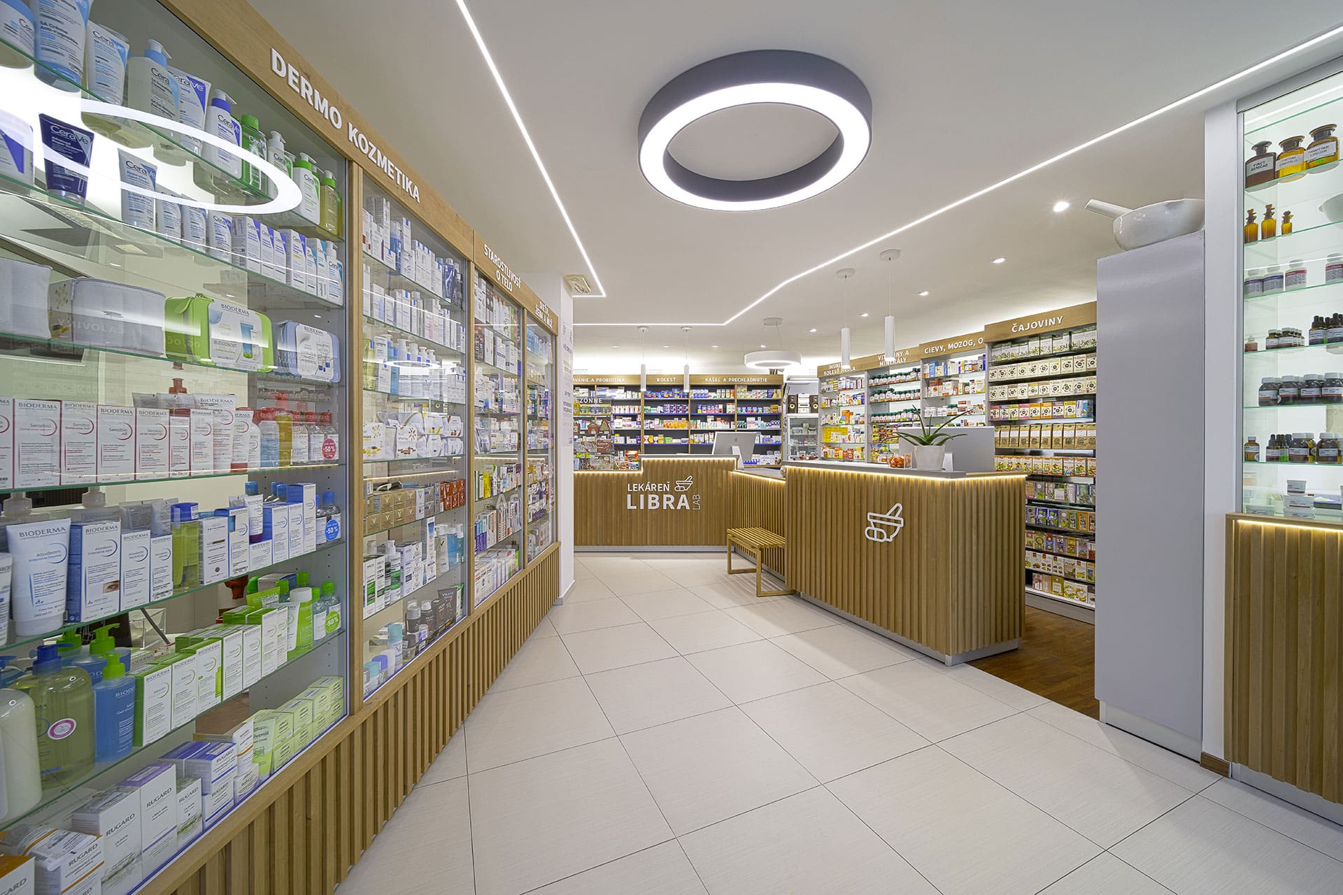 Pharmacy interior with Thermory thermo-alder STEP wall panels and shelving, showcasing natural wood warmth in a bright, contemporary space.