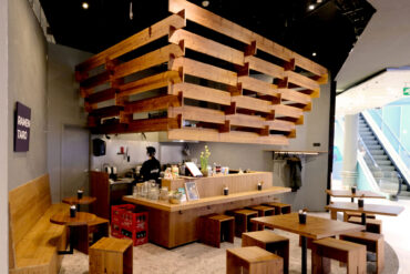 Interior of Ramen Taro restaurant featuring Thermory thermo-spruce furniture and ceiling structure, blending warm natural tones with Japanese minimalism.