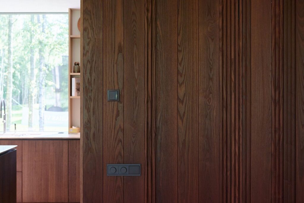 Rich wooden wall with natural grain, creating a warm and stylish modern interior.